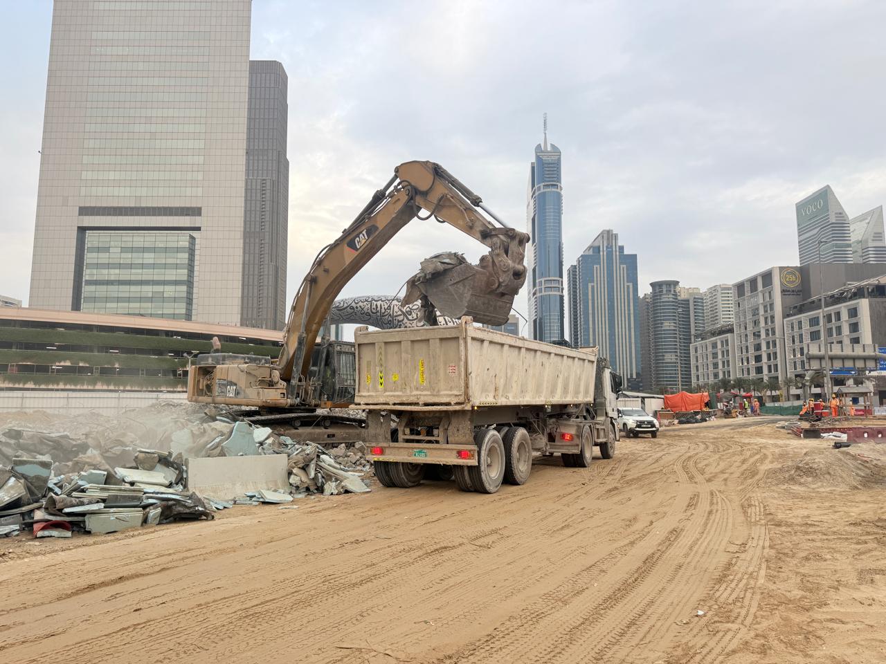 Lincoln Demolition excavator clearing a structural demolition near the Dubai skyline